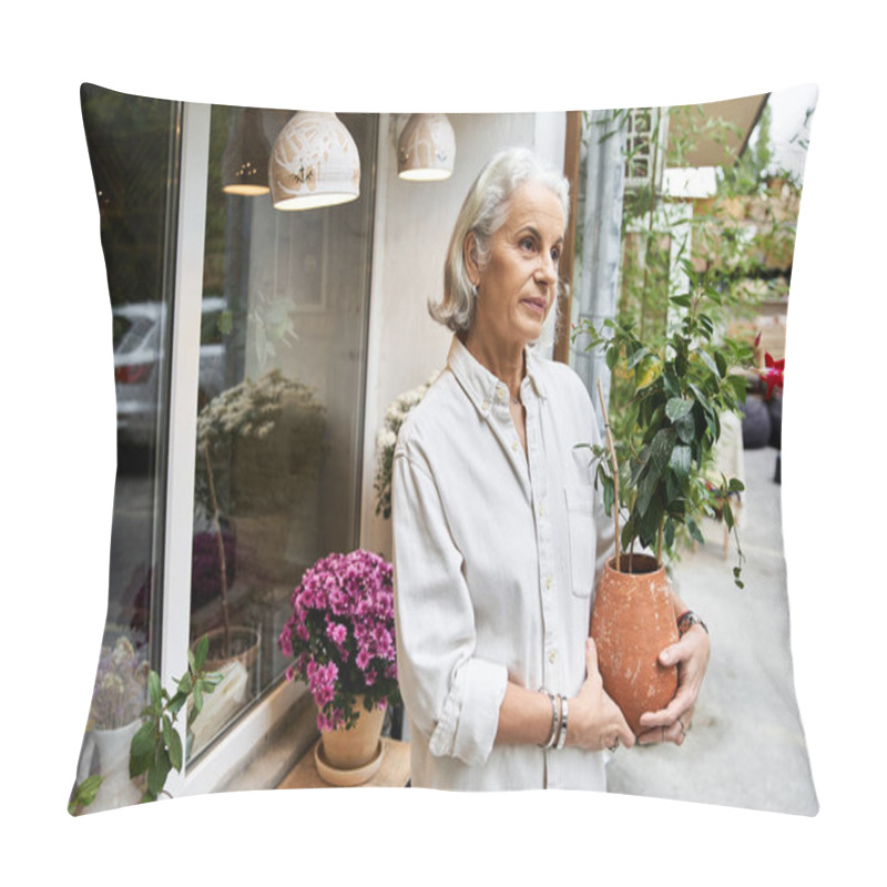 Personality  A Serene Mature Woman Stands Gracefully With A Potted Plant In A Cozy Cafe. Pillow Covers