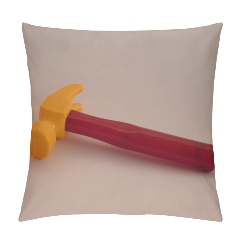 Personality  A Vibrant Toy Hammer With A Yellow Head And Red Handle Lies On A Neutral Background, Symbolizing Creativity, Playful Learning, And The Tools Of Childhood Exploration, Blending Simplicity And The Power Of Imagination. Pillow Covers