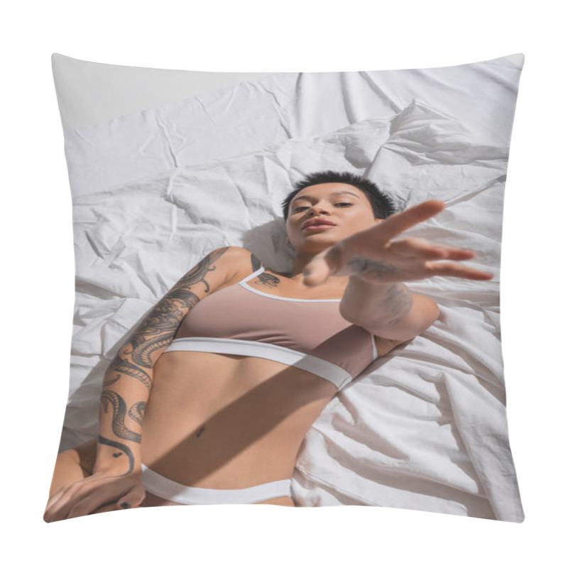 Personality  Top View Of Intriguing Young Woman In Beige Lingerie, With Short Brunette Hair And Sexy Tattooed Body Laying On White Bedding With Outstretched Hand And Looking At Camera In Studio Pillow Covers