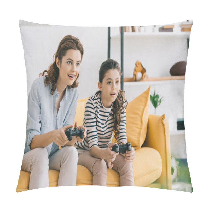 Personality  KYIV, UKRAINE - APRIL 8, 2019: Smiling Mother And Daughter Playing Video Game While Sitting On Sofa At Home Pillow Covers