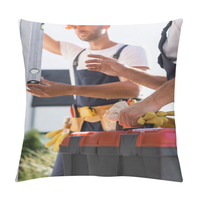 Personality  Selective Focus Of Workman Holding Gloves And Toolbox While Colleague Using Spirit Level Near House  Pillow Covers