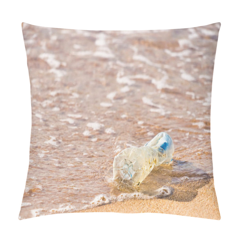 Personality  A Plastic Bottle Litters The Beach, A Stark Reminder Of The Ongoing Issue Of Ocean Pollution. Pillow Covers