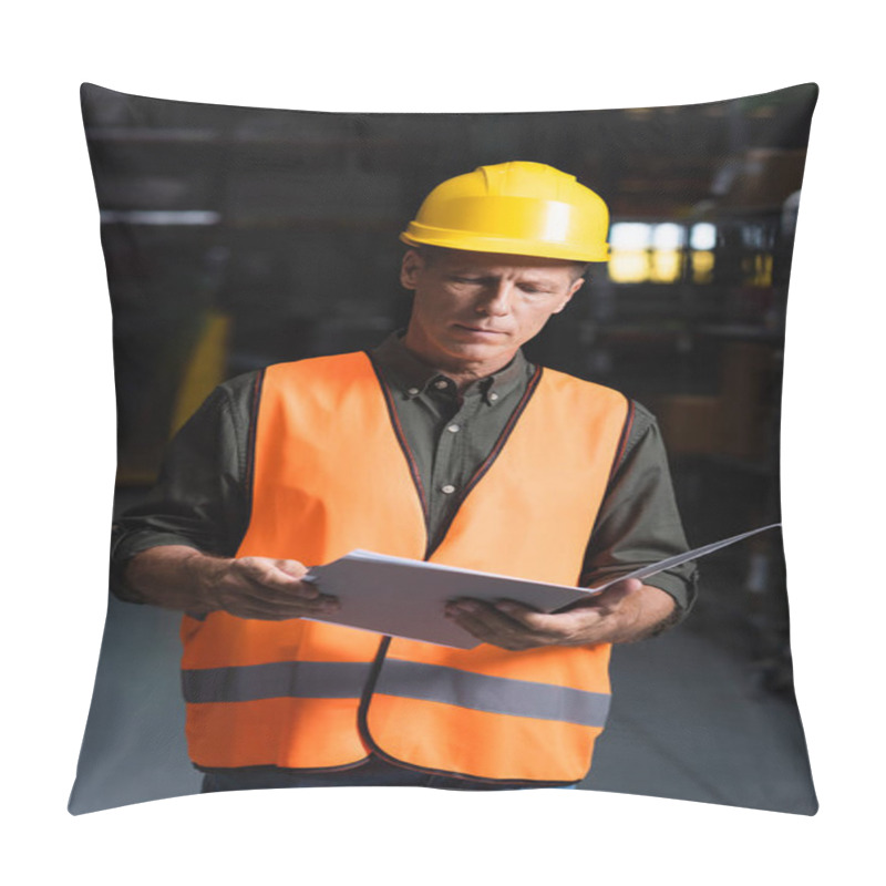 Personality  Focused Middle Aged Supervisor In Hard Hat Reviewing Paperwork In Warehouse, Logistics And Cargo Pillow Covers