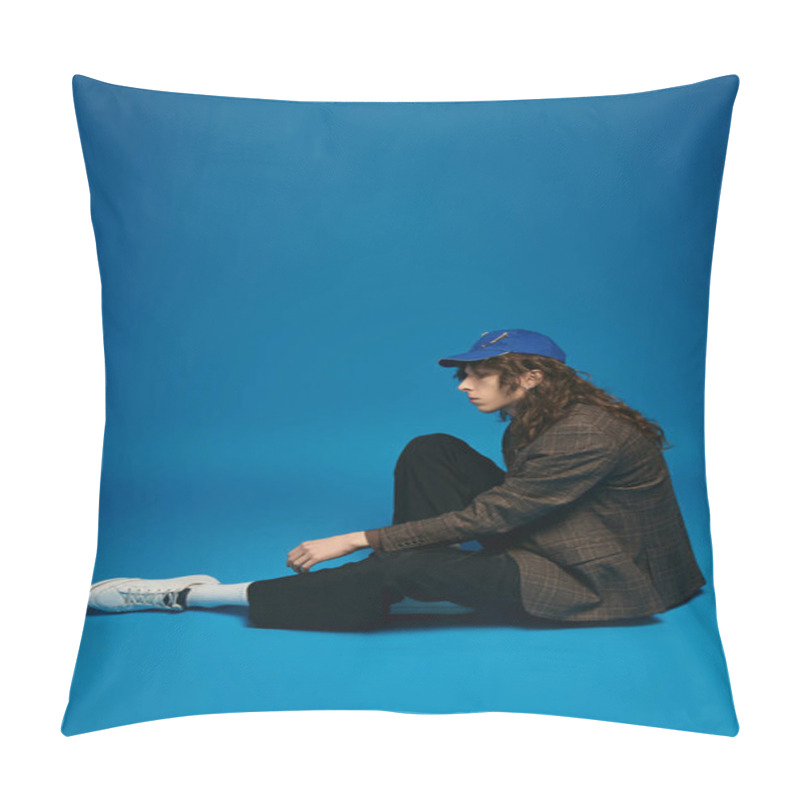 Personality  A Fashionable Young Man Sits Gracefully, Showcasing His Trendy Look In A Striking Blue Ambiance. Pillow Covers