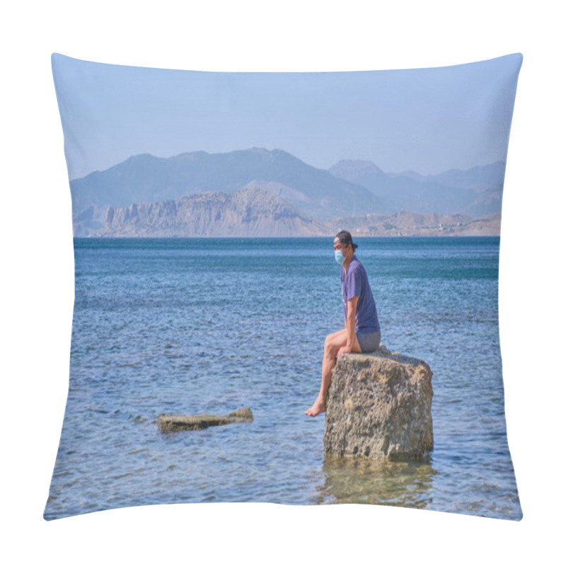 Personality  Sad Senior Asian Man In Face Mask, Shorts, T-shirt And Baseball Cap Sits Alone On A Stone In A Sea Bay Against A Background Of Mountains Pillow Covers