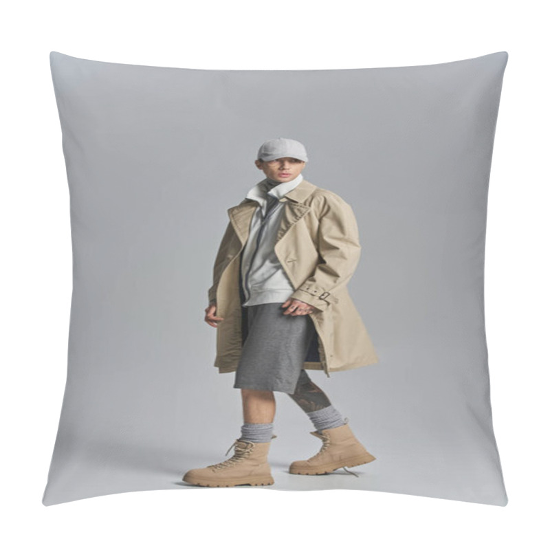 Personality  Young Tattooed Man In Trench Coat And Hat, Striking A Confident Pose In A Studio Setting Against A Grey Background. Pillow Covers