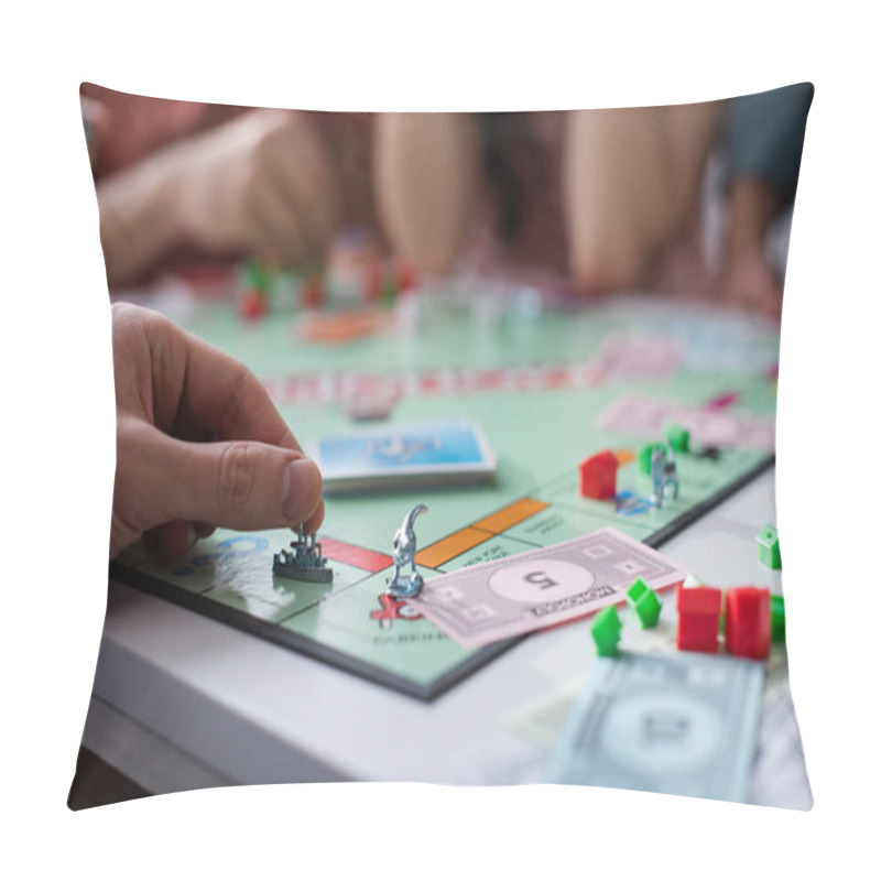 Personality  KYIV, UKRAINE - JANUARY 27, 2020: Cropped View Of Man Holding Toy Figurine While Playing Monopoly Game With Friends Pillow Covers