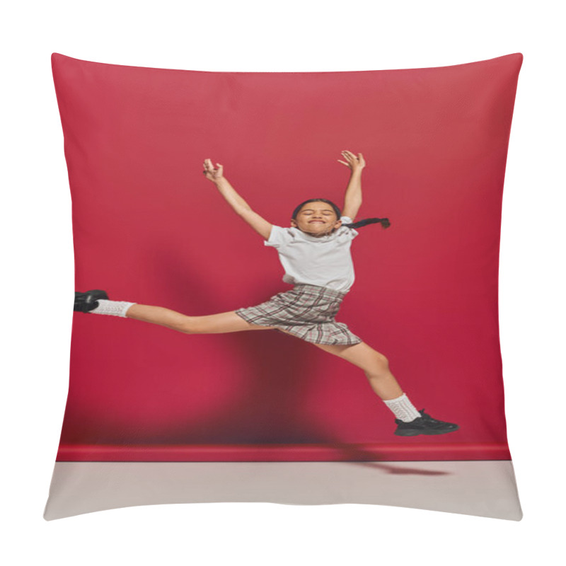 Personality  Excited And Cheerful Preteen Girl In White T-shirt And Stylish Checkered Skirt Jumping And Having Fun While Posing On Red Background, Hairstyle And Trendy Accessories Concept Pillow Covers