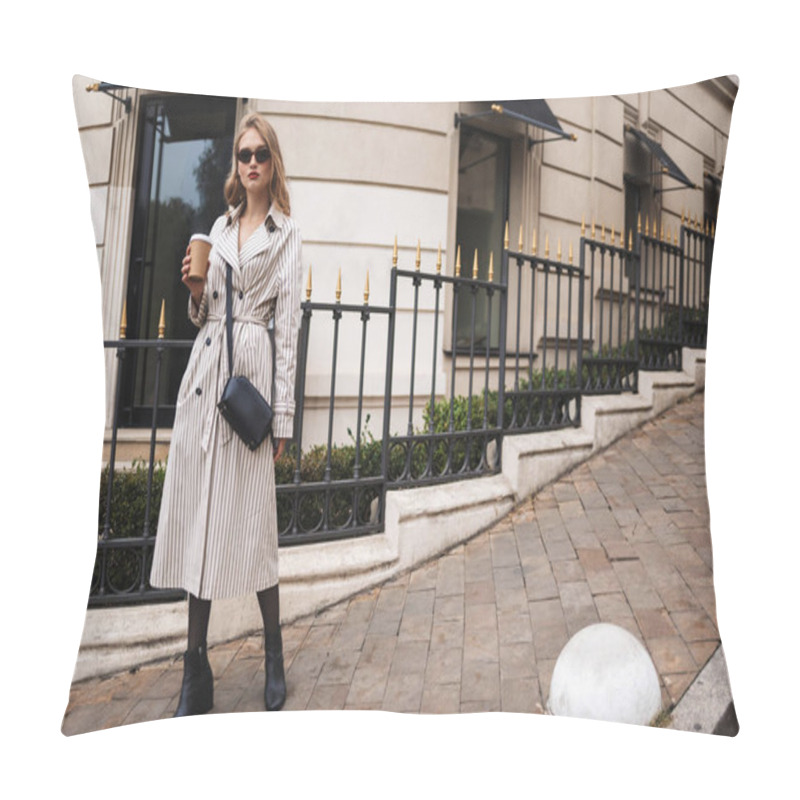 Personality  Young Attractive Woman In Striped Trench Coat And Sunglasses With Little Black Cross Bag Holding Coffee To Go In Hand Thoughtfully Looking In Camera Walking Around City Street Pillow Covers