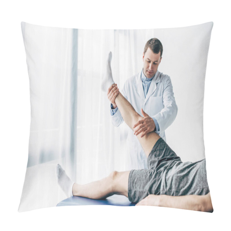 Personality  Handsome Physiotherapist Stretching Leg Of Patient On Massage Table In Hospital Pillow Covers