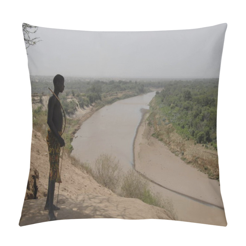 Personality  VALLEY OMO, ETHIOPIA, MARCH 15, 2012: Unidentified Karo Boy Poses With His Bow On The River Omo Background In Colcho, Omo Valley, Ethiopia. Karo Boys Fend For Themselves Instead Of Studying At School. Pillow Covers