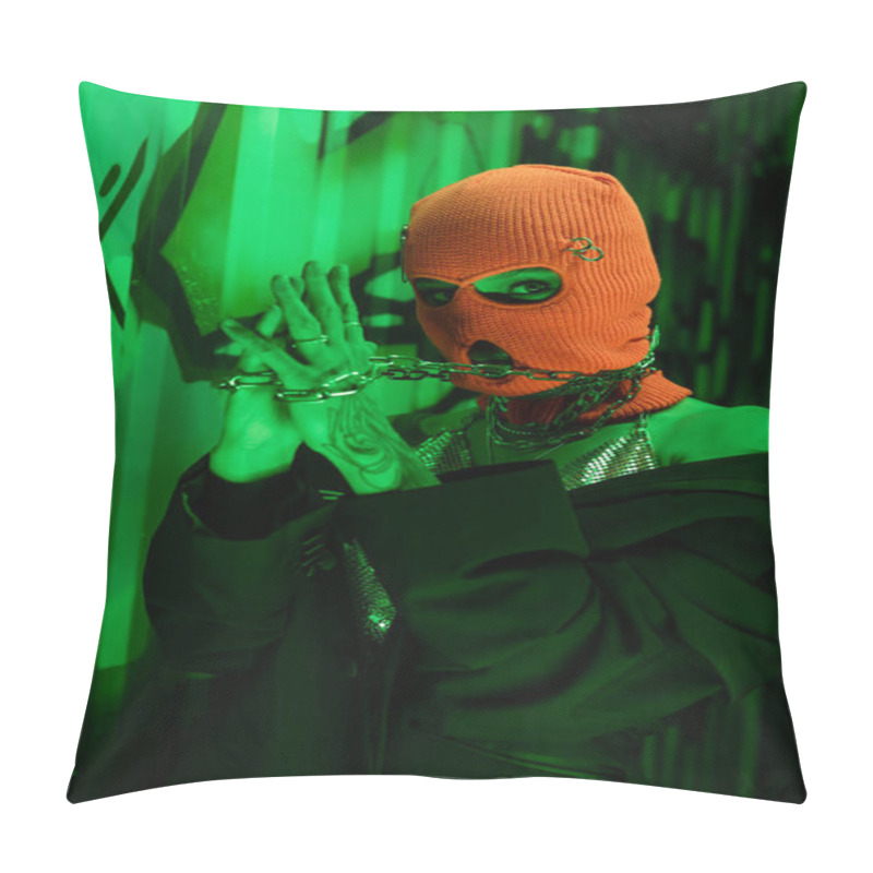 Personality  Sexy Tattooed Woman In Black Blazer And Orange Balaclava Holding Silver Neck Chains Near Green Wall With Graffiti Pillow Covers