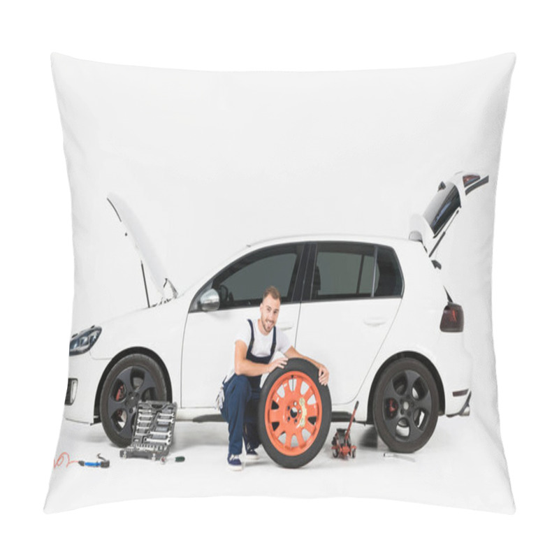 Personality  Smiling Auto Mechanic Changing Car Tire And Looking At Camera On White Pillow Covers