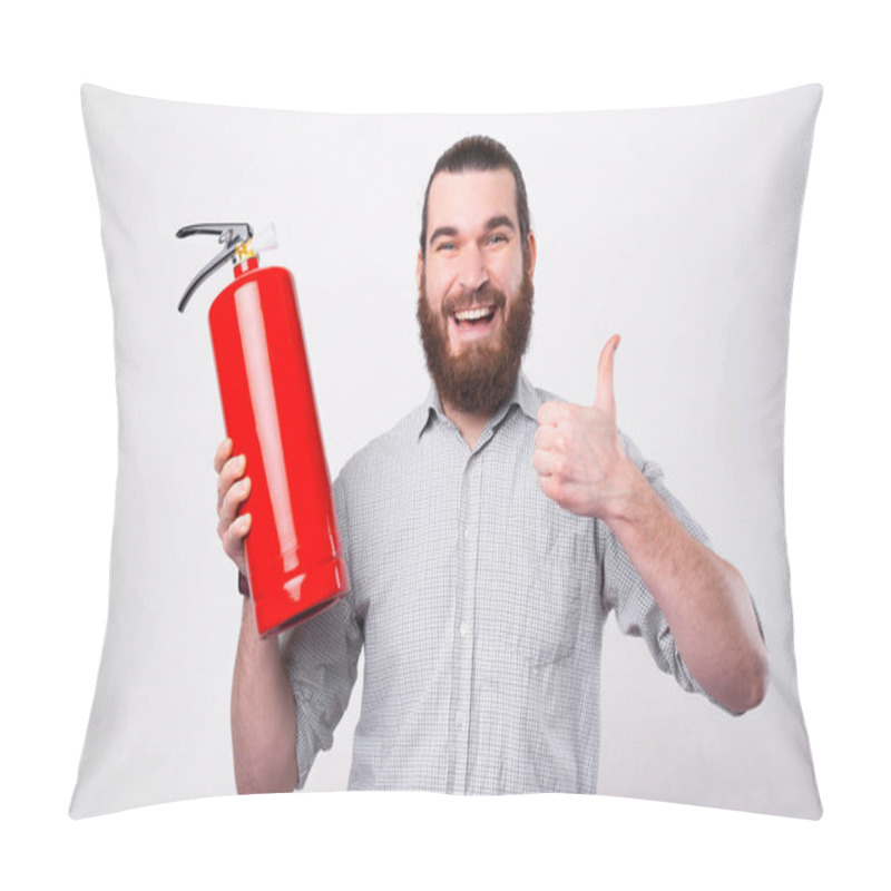 Personality  A Young Bearded Man Is Looking And Smiling At The Camera Holding A Fire Extinguisher And A Thumg Up Near A White Wall Pillow Covers