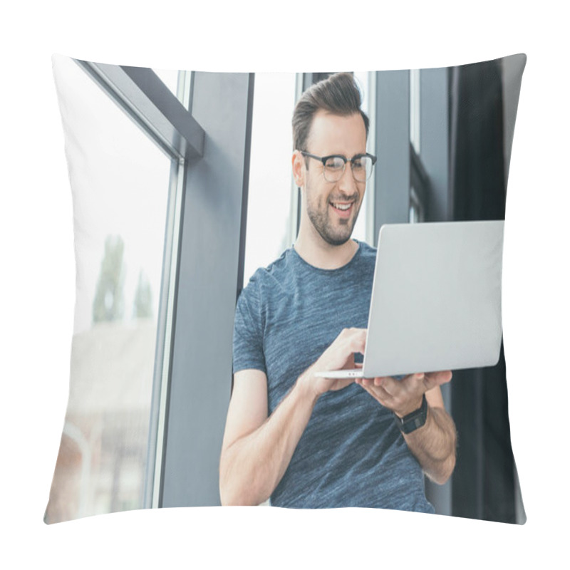 Personality  Smiling Young Man In Eyeglasses Using Laptop Near Window Pillow Covers