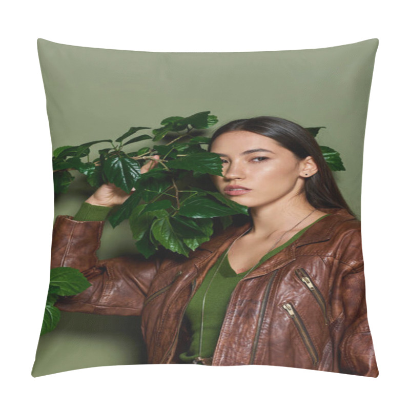 Personality  Brunette Woman Dressed In Brown Leather Jacket Stands Confidently Amidst Vibrant Green Foliage Pillow Covers