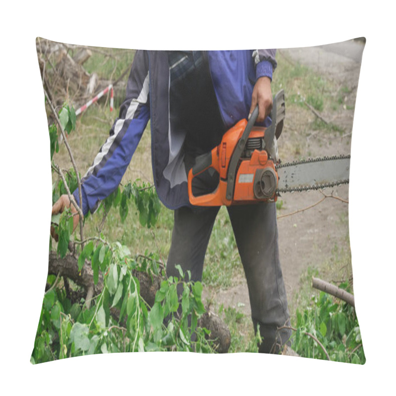 Personality  A Utility Worker In A Blue Jacket With A Chainsaw Cuts Trees And Cleans Branches In A Garden, Park Or Square. Sanitary Pruning Of Trees. City Economy And Accomplishment Pillow Covers