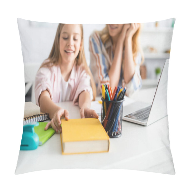 Personality  Selective Focus Of Smiling Kid Taking Book Near Mother And Laptop On Table  Pillow Covers