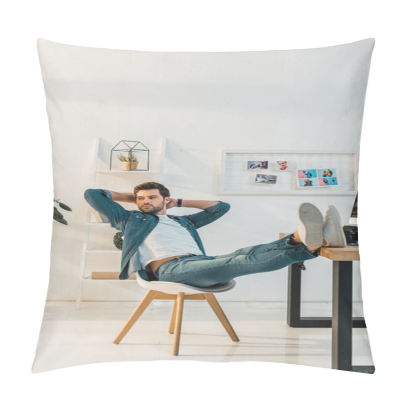 Personality  Relaxed Young Retoucher Sitting With Hands Behind Head And Legs On Work Desk  Pillow Covers