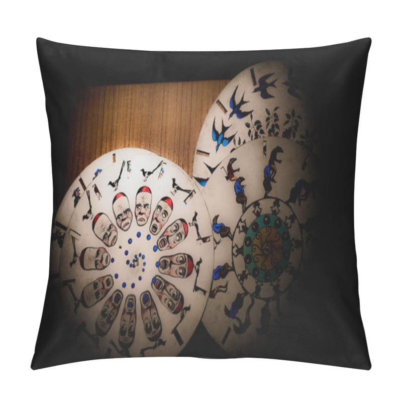 Personality  Intricate Circular Designs Display Vibrant Traditional Artwork, Showcasing Various Figures And Motifs Against Natural Wood. The Soft Lighting Enhances The Details. Pillow Covers