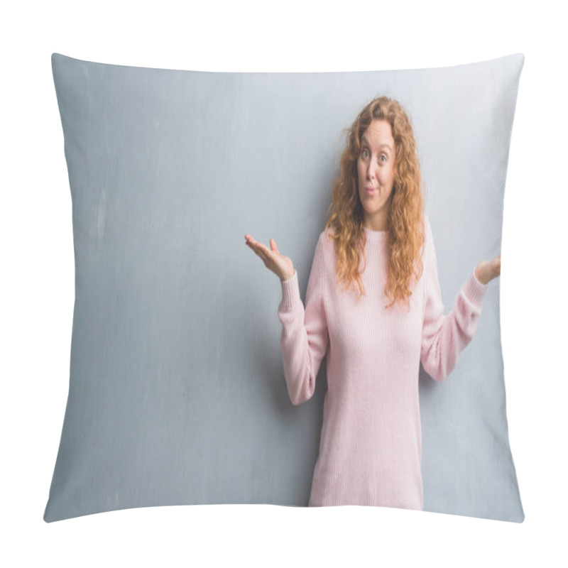 Personality  Young Redhead Woman Over Grey Grunge Wall Wearing Pink Sweater Clueless And Confused Expression With Arms And Hands Raised. Doubt Concept. Pillow Covers