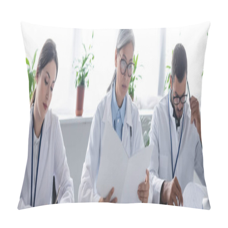 Personality  Thoughtful Doctor Touching Head With Pen While Working Near Multiethnic Colleagues, Banner Pillow Covers