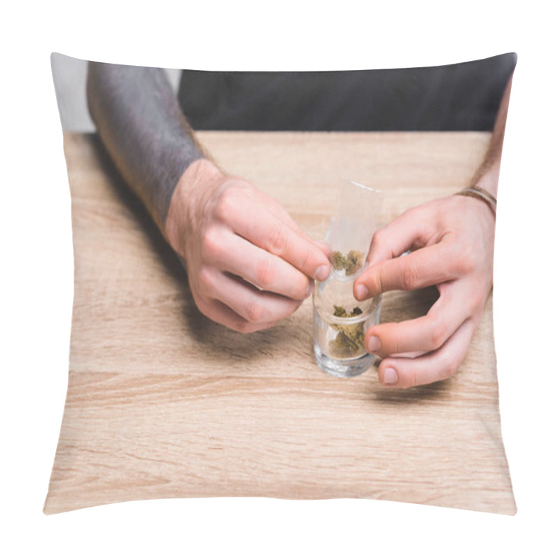 Personality  Cropped View Of Young Man Rolling Joint With Weed While Sitting Behind Table  Pillow Covers