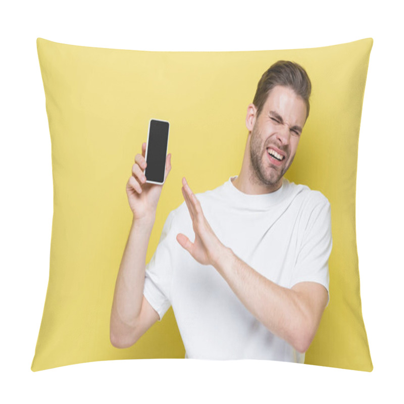 Personality  Man Feeling Disgust And Showing Refuse Gesture While Holding Cellphone With Blank Screen On Yellow Pillow Covers