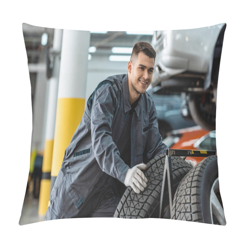 Personality  Handsome, Smiling Mechanic Holding New Tire In Workshop Pillow Covers