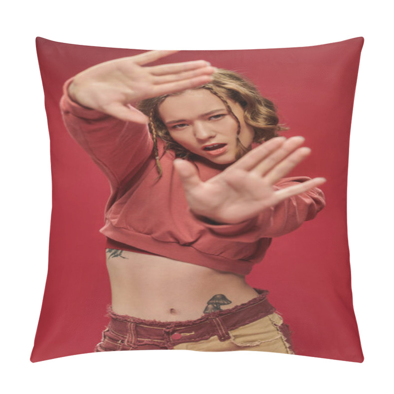 Personality  Self-expression, Stylish Young Woman In Cropped Long Sleeve Showing Frame Gesture With Hands On Red Pillow Covers