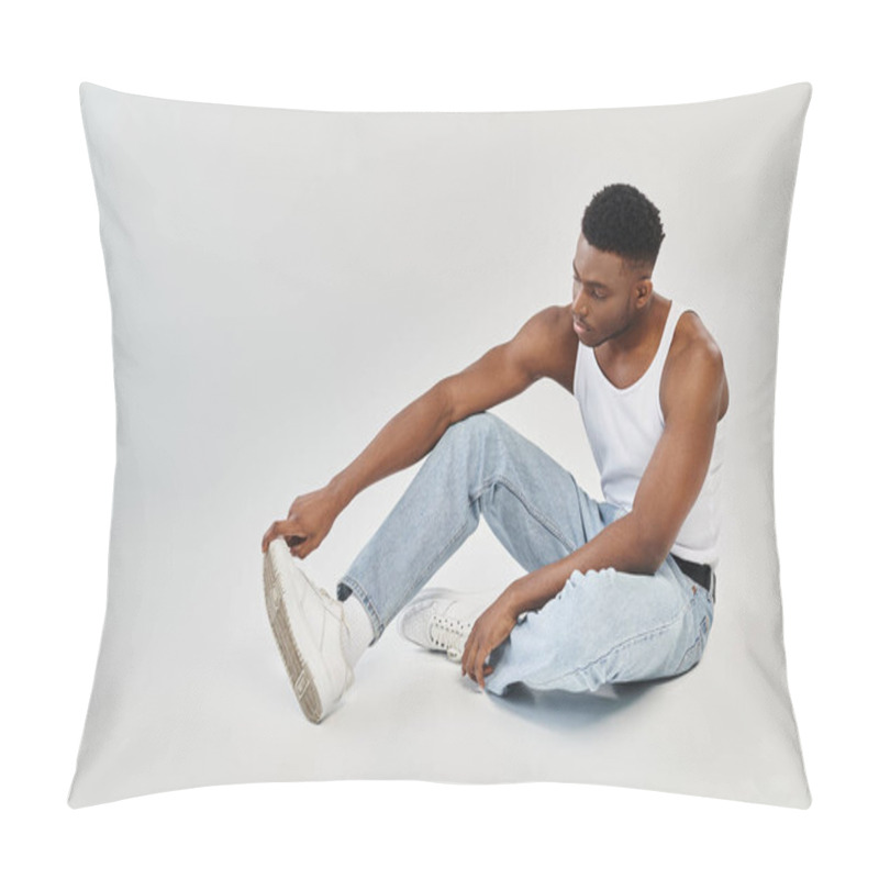 Personality  A Young And Stylish African American Man Sits Calmly On The Ground In Casual Attire Of Jeans And A Tank Top. Pillow Covers