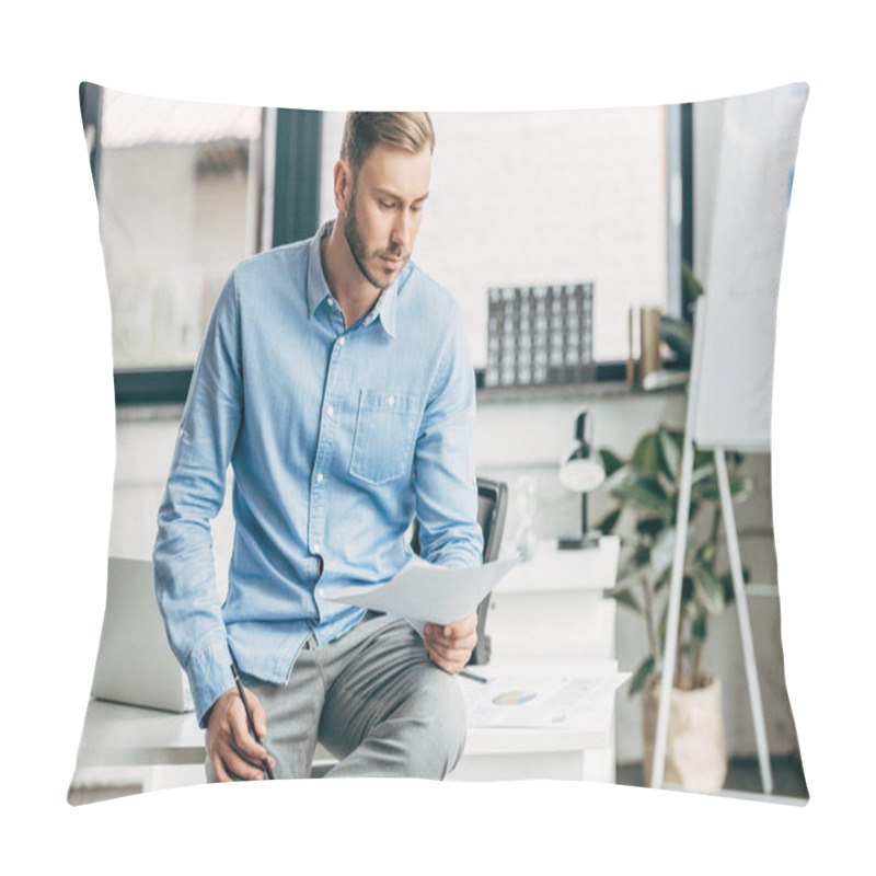 Personality  Serious Young Businessman Holding Papers And Sitting On Table In Office Pillow Covers