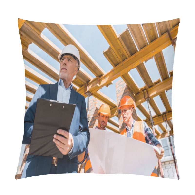 Personality  Low Angle View Of Bearded Mature Businessman With Clipboard Near Builders  Pillow Covers