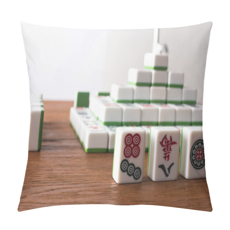 Personality  KYIV, UKRAINE - JANUARY 30, 2019: Selective Focus Of Rows And Pyramid Made Of Mahjong Game Tiles On Wooden Table Isolated On White Pillow Covers