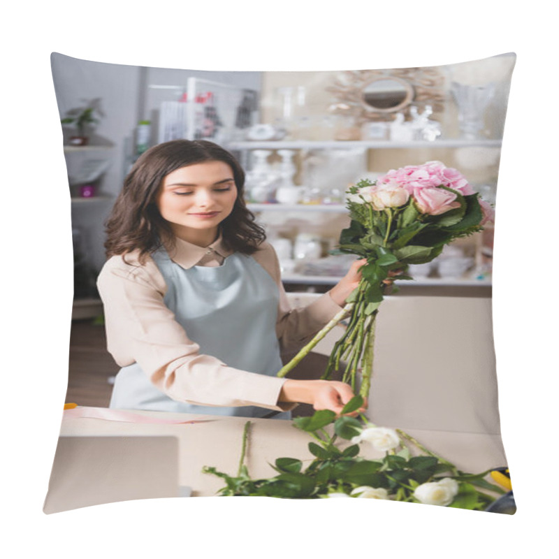 Personality  Positive Female Florist Taking Rose From Desk, While Arranging Bouquet With Blurred Racks Of Vases On Background Pillow Covers