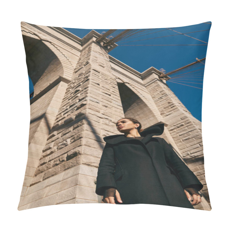 Personality  A Young Woman In A Black Coat Stands Beneath The Imposing Arch Of A New York City Bridge. Pillow Covers