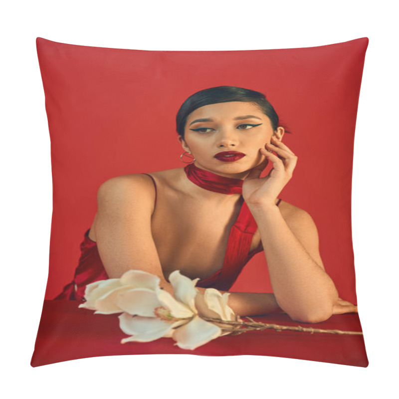 Personality  Dreamy Asian Woman With Brunette Hair And Bold Makeup Holding Hand Near Face And Looking Away Near White Orchid On Red Background, Spring Fashion, Strap Dress, Stylish Neckerchief Pillow Covers