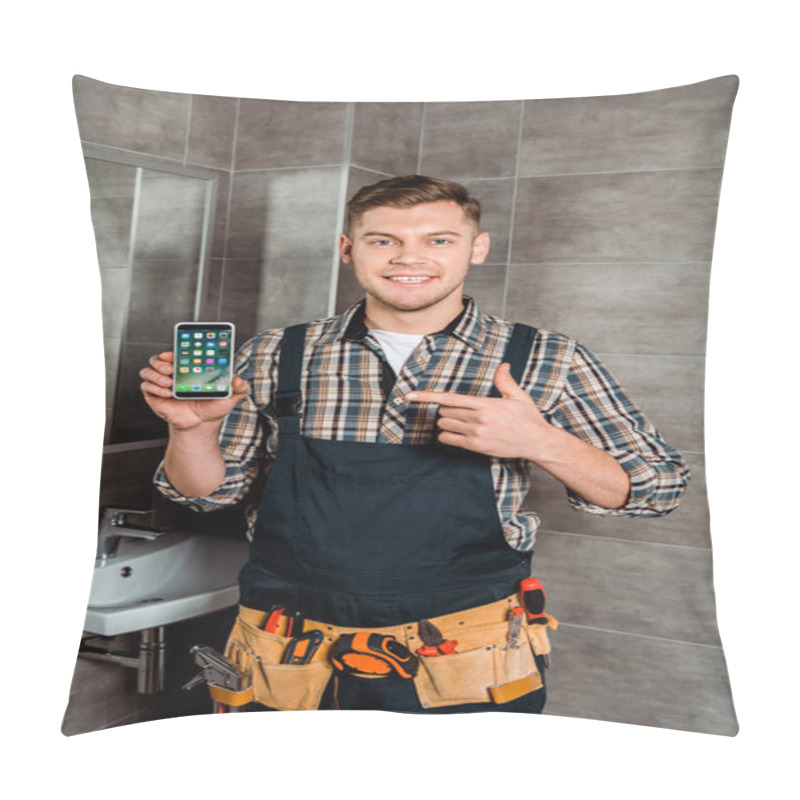 Personality  KYIV, UKRAINE - DECEMBER 4, 2019: Happy Installer Pointing With Finger At Iphone In Bathroom  Pillow Covers