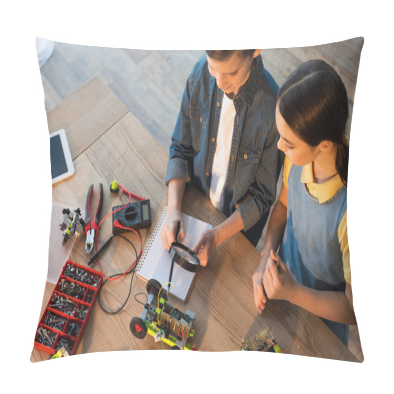 Personality  High Angle View Of Boy Holding Magnifier Near Notebook And Pointing With Pencil At Robotics Model Pillow Covers