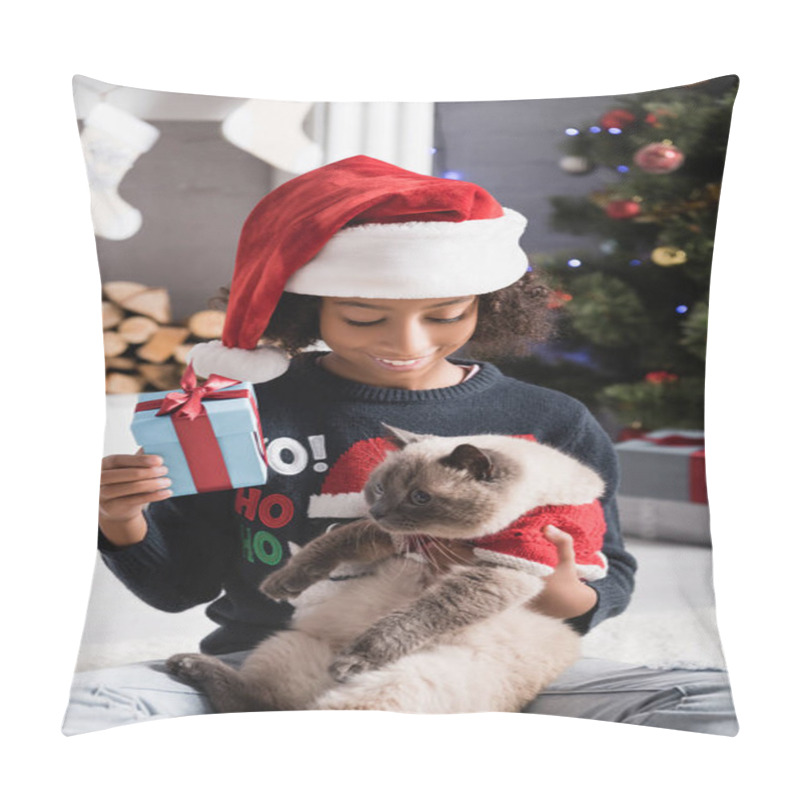 Personality  Joyful African American Girl Holding Fluffy Cat And Gift Box Near Christmas Decoration On Blurred Background Pillow Covers