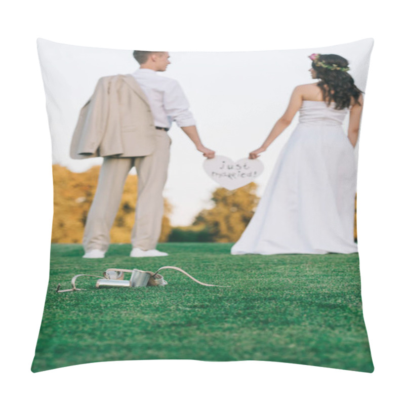 Personality  Back View Of Young Wedding Couple Standing On Green Lawn And Holding Heart With Just Married Inscription Pillow Covers