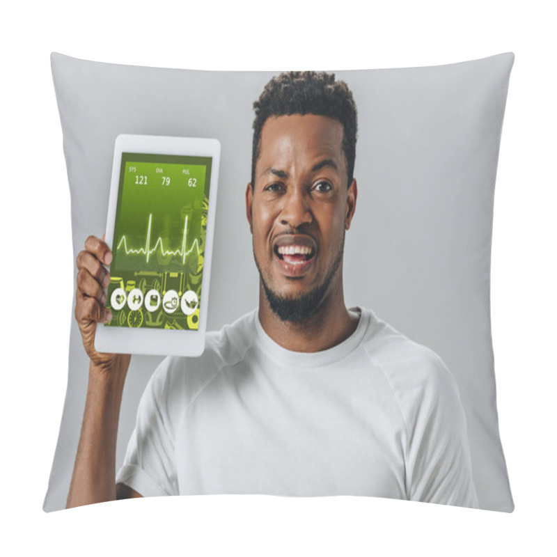 Personality  Upset African American Man Holding Digital Tablet With Fitness Application And Looking At Camera Isolated On Grey Pillow Covers