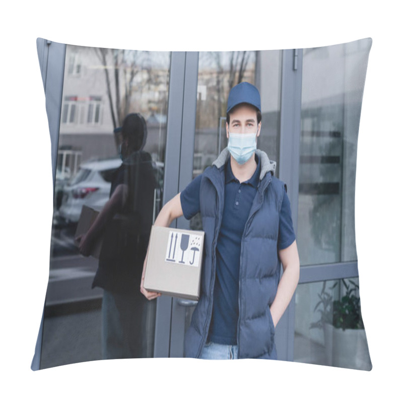 Personality  Young Delivery Man In Medical Mask Holding Cardboard Box And Looking At Camera Near Building Outdoors  Pillow Covers