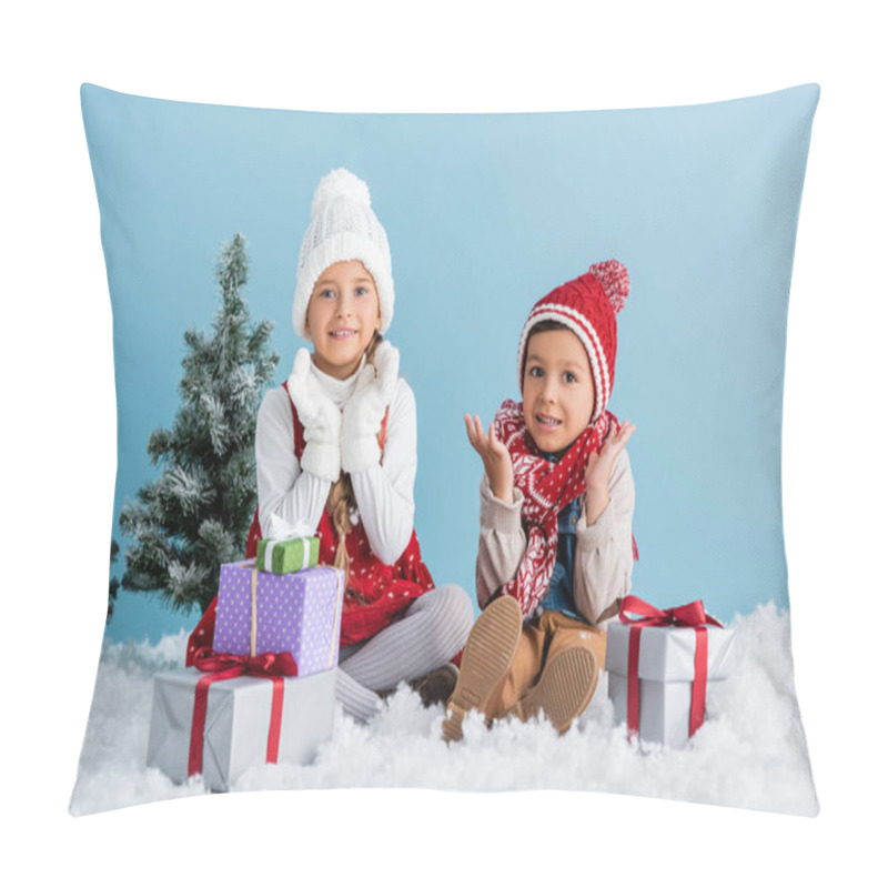 Personality  Children In Winter Outfit Sitting On Snow And Gesturing Near Presents And Fir Isolated On Blue Pillow Covers