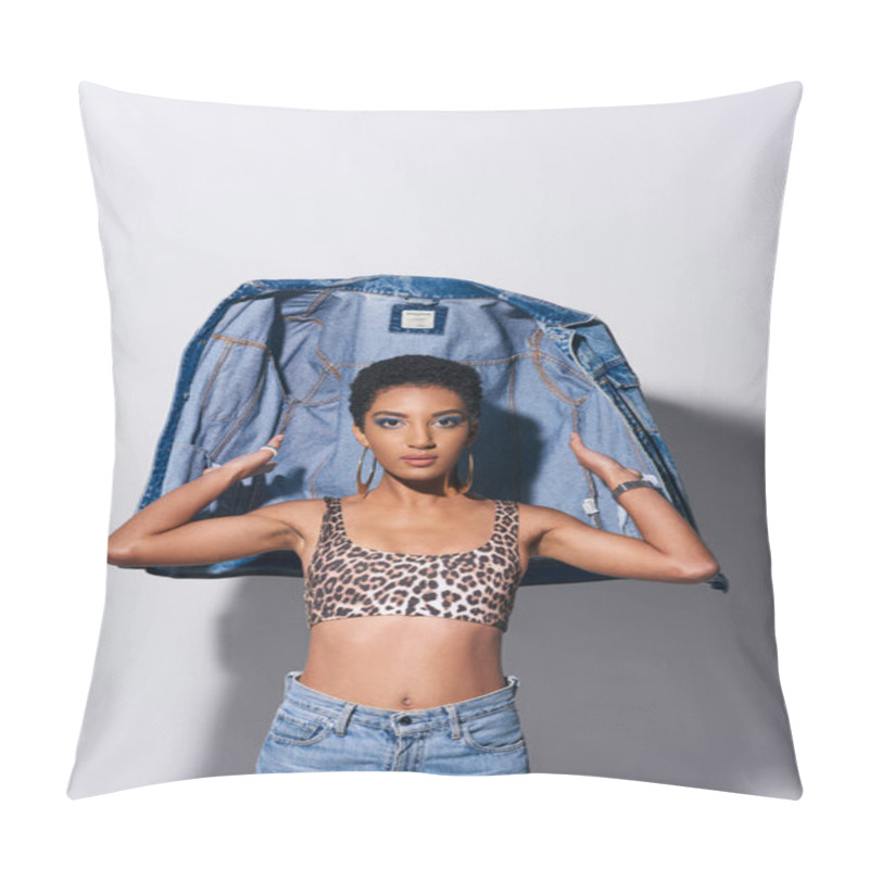 Personality  Stylish African American Woman With Short Hair And Bold Makeup Wearing Top With Animal Print And Jeans While Posing With Denim Jacket On Grey Background, Denim Fashion Concept Pillow Covers