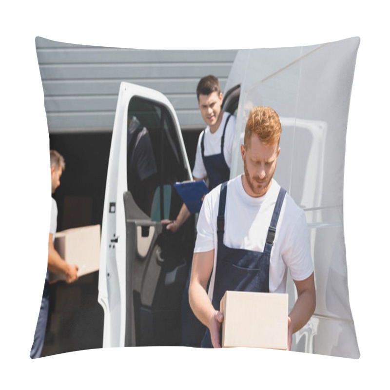 Personality  Selective Focus Of Loader Holding Cardboard Box While Colleagues Working Near Truck On Urban Street  Pillow Covers