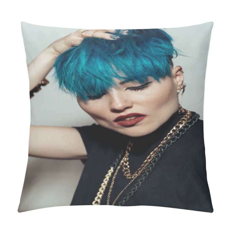 Personality  fashion photography of a girl with blue hair on a white background looking directly at the camera. Thick yellow chain and bijouterieher on her neck. Professional model posing in studio pillow covers