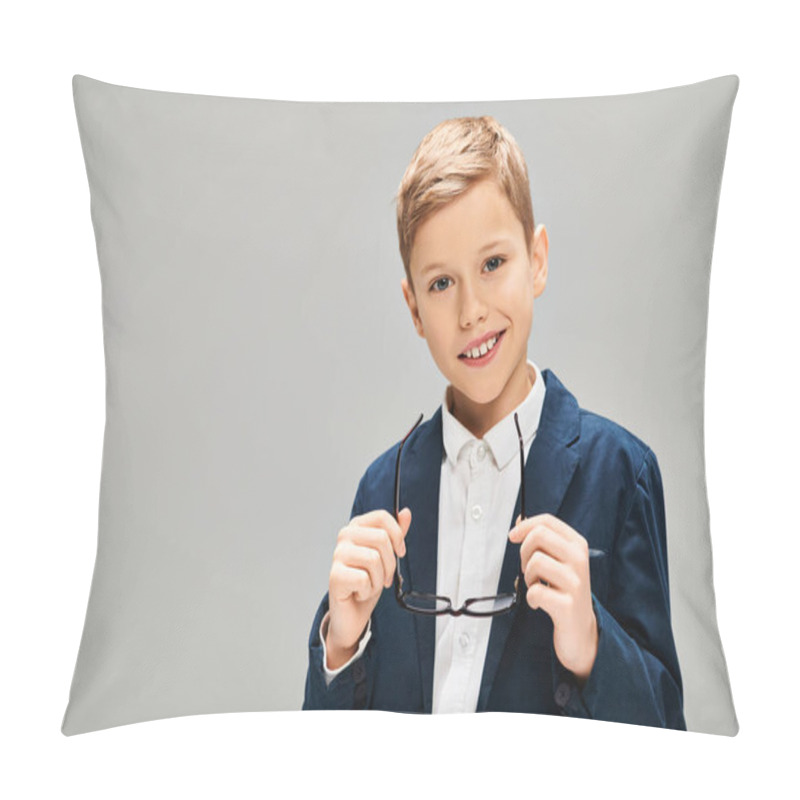 Personality  Young Boy In Elegant Attire Holds A Pair Of Glasses Against A Gray Backdrop. Pillow Covers