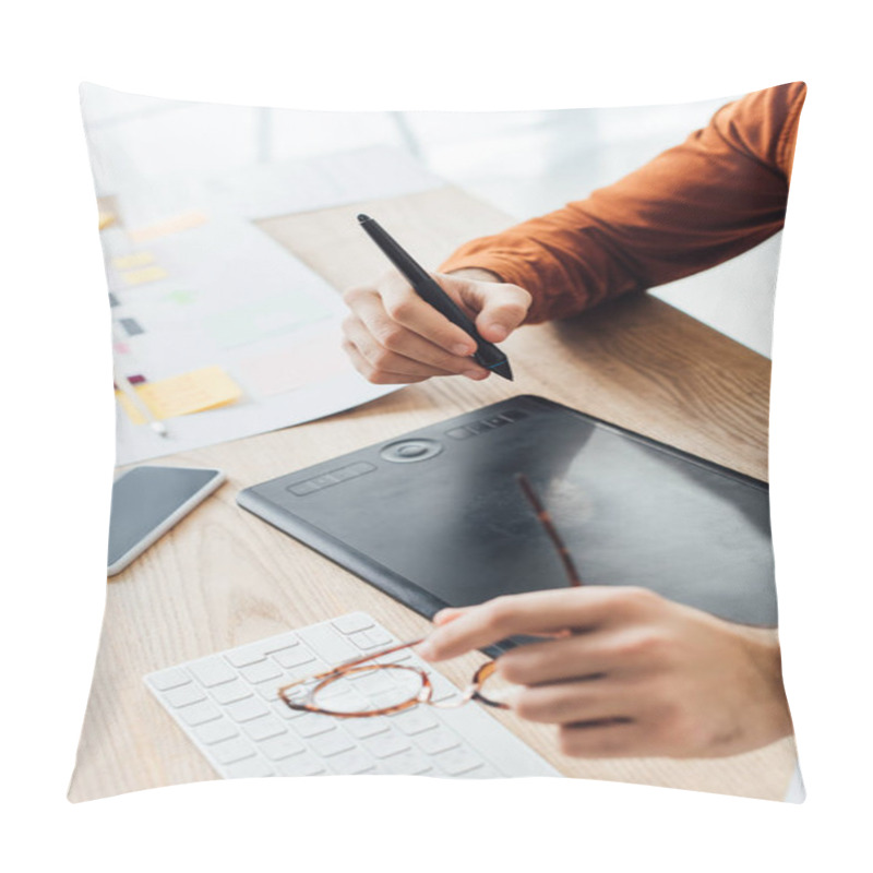 Personality  Selective Focus Of Ux Designer Holding Eyeglasses While Using Graphics Tablet Near Smartphone And Layouts On Table Pillow Covers