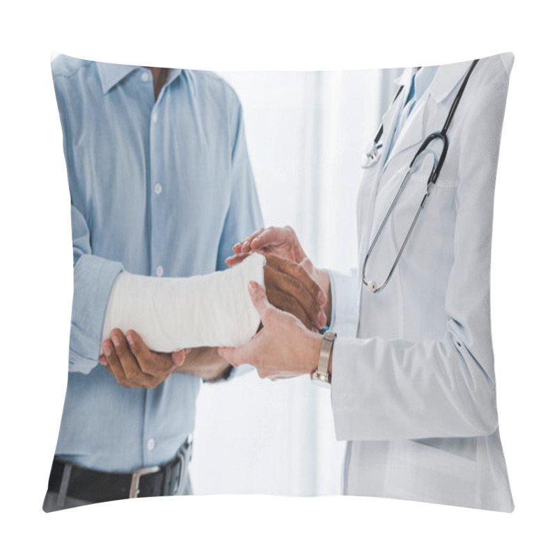 Personality  Cropped View Of Doctor Touching Broken Arm On Injured Man In Clinic  Pillow Covers